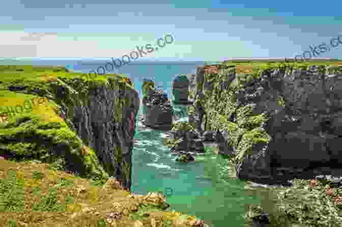 A Couple Hiking Along A Coastal Path In The Pembrokeshire Coast National Park, With Stunning Views Of The Sea And Cliffs Walking In Pembrokeshire: 40 Circular Walks In And Around The Pembrokeshire Coast National Park (British Walking)