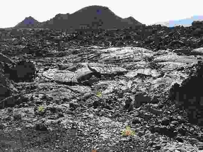 A Panoramic View Of The Desolate And Surreal Landscape Of Craters Of The Moon National Monument, With Its Rolling Hills, Jagged Lava Formations, And Distant Cinder Cones Craters Of The Moon: Craters Of The Moon National Monument