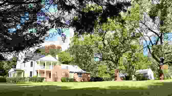 Visitors Exploring The Historic Buildings Of Cherokee Plantation, Surrounded By Lush Greenery And Blooming Flowers. The House On Diamond Hill: A Cherokee Plantation Story